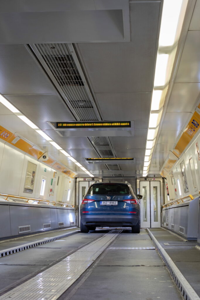 Blue car on board of Eurotunnel train connecting the UK and France. A journey to cross the English channel takes only 35 minutes